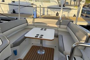 Luxurious 2015 Alfastreet 23 boat interior with cushioned seating and table.