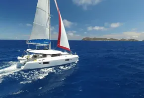 Lagoon 42 sailing catamaran, 2020 model, cruising in clear blue ocean near islands.