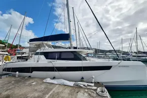 2019 Leopard 50 catamaran docked at marina under cloudy sky.