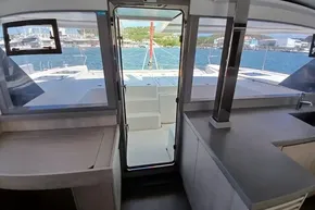 Interior view of 2018 Leopard 45 catamaran with open door to deck and ocean view.