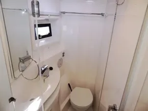 Compact bathroom in 2015 Leopard 51 Powercat with sink, toilet, and shower.