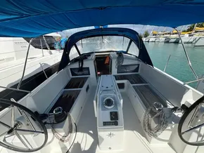 2019 Jeanneau Sun Odyssey 440 cockpit with dual steering wheels and blue canopy.