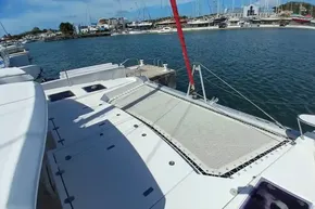 2018 Leopard 45 catamaran docked at marina, featuring spacious deck and netting.