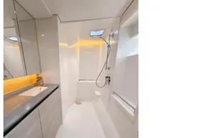 Modern yacht bathroom with sleek design, featuring a shower, sink, and toilet. Leopard 50, 2020 model.