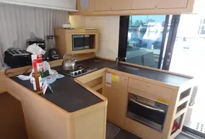 Modern kitchen in a 2020 Lagoon 42 catamaran with appliances and ample counter space.