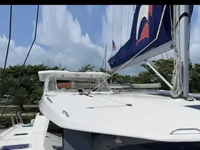 Leopard 50 catamaran, 2020 model, docked with sails up against a clear sky.