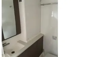 Modern bathroom in 2022 Leopard 45 yacht with sink, mirror, and toilet.