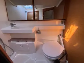 Bathroom interior of 2019 Jeanneau Sun Odyssey 440 yacht, featuring modern fixtures and natural lighting.