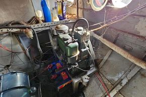 Engine room of a 1927 Classic Dutch Barge with visible machinery and wiring.