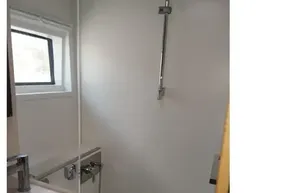 Bathroom interior of 2020 Lagoon 46 yacht, featuring modern fixtures and window.