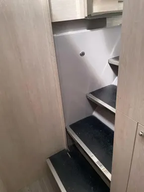 Interior stairs of a 2020 Leopard 50 yacht, featuring sleek black steps.