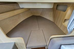 Cozy interior cabin of 2023 Balt 818 Titanium boat with wooden accents and cushioned seating.