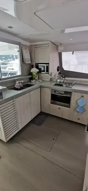 Modern kitchen interior of 2019 Leopard 51 Powercat yacht with appliances and window view.