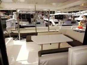Leopard 40 catamaran's outdoor seating area with table, docked at marina, 2021 model.
