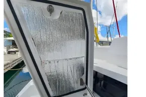 Open hatch on 2020 Leopard 50 boat, showing reflective insulation under blue sky.