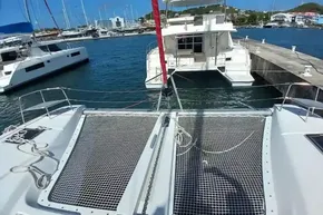 2020 Lagoon 46 catamaran docked at marina, featuring spacious deck and netting.