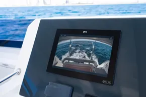 2025 Leopard 40 Powercat helm with rear-view display, ocean backdrop.