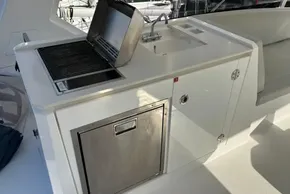 Outdoor kitchen on 2024 Leopard 40 Powercat with grill, sink, and storage.