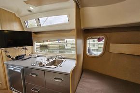 Modern kitchen interior of 2023 Balt 818 Titanium boat with stove, sink, and TV.
