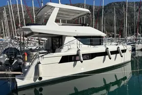 2024 Leopard 40 Powercat yacht docked in a marina with scenic mountain backdrop.