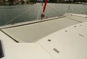 Leopard 45 catamaran deck with netting, 2017 model, docked in a serene harbor.