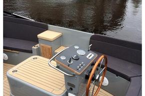 2026 Enkhuizensloep 744 Tender boat interior with wooden steering wheel and modern controls.
