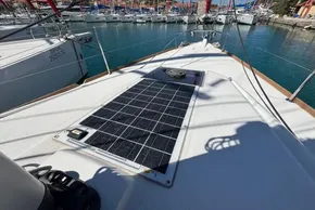 2020 Jeanneau Sun Odyssey 389 sailboat with solar panel on deck, docked in marina.