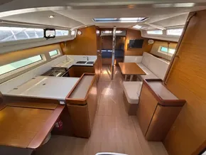 Interior of 2019 Jeanneau Sun Odyssey 440 yacht, featuring modern kitchen and seating area.