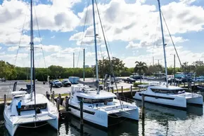 Three Leopard 46 catamarans docked at a marina under a partly cloudy sky, 2025 model.