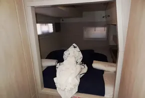 2017 Leopard 43 Powercat cabin with neatly arranged bed and towel art.