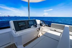 2025 Leopard 40 Powercat helm with ocean view, featuring modern navigation equipment and seating.