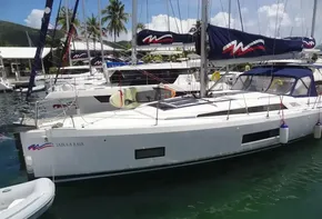 2020 Beneteau Oceanis 46.1 sailboat docked in a marina with palm trees.