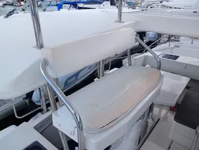 Captain's seat on a 2021 Leopard 40 catamaran, featuring white upholstery and stainless steel frame.