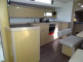 Interior of 2017 Beneteau Oceanis 45 yacht, featuring modern kitchen and seating area.