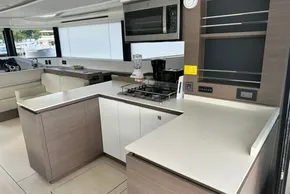 Modern kitchen interior of 2022 Leopard 53 Powercat yacht with sleek countertops and appliances.