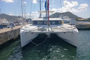 2020 Lagoon 46 catamaran docked at a marina with scenic mountain backdrop.