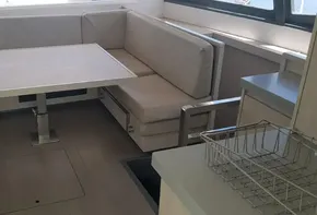 Interior of 2017 Leopard 48 yacht with dining area and beige seating.