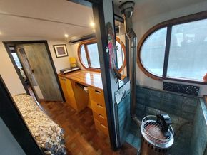 Kitchen counters, breakfast bar, sink, and water heater