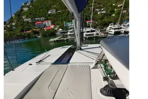 2021 Leopard 50 yacht deck with sunbathing area, docked near lush green hills.