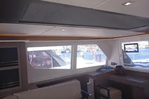 Interior of 2022 Leopard 45 yacht with large windows and modern furnishings.