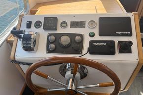 Control panel of 2024 Piper 12c boat with steering wheel and Raymarine navigation equipment.
