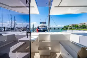2022 Leopard 50 yacht interior with marina view, featuring sleek seating and modern design.