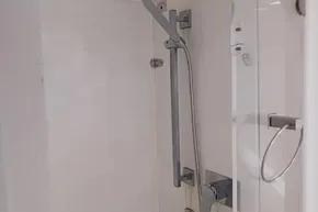 Modern shower area in a 2017 Leopard 48 yacht, featuring sleek fixtures and glass door.