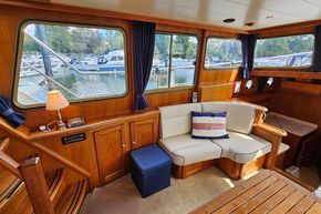 Interior of 2005 Stevens 1200 Vlet boat with cozy seating and marina view.