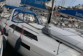 2019 Beneteau Oceanis 41.1 sailboat docked in marina with blue sails.