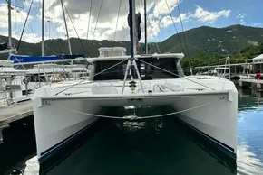 2021 Leopard 50 catamaran docked in a scenic marina with lush hills.