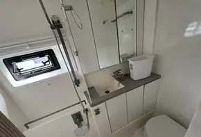 2019 Leopard 45 yacht bathroom with shower, sink, mirror, and toilet.
