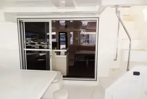 2015 Leopard 51 Powercat yacht interior with sliding glass door and staircase.