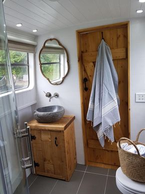 Riverstone sink, handcrafted woodwork, antique mirror