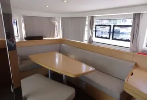 Interior of 2020 Lagoon 42 catamaran with dining area and large windows.